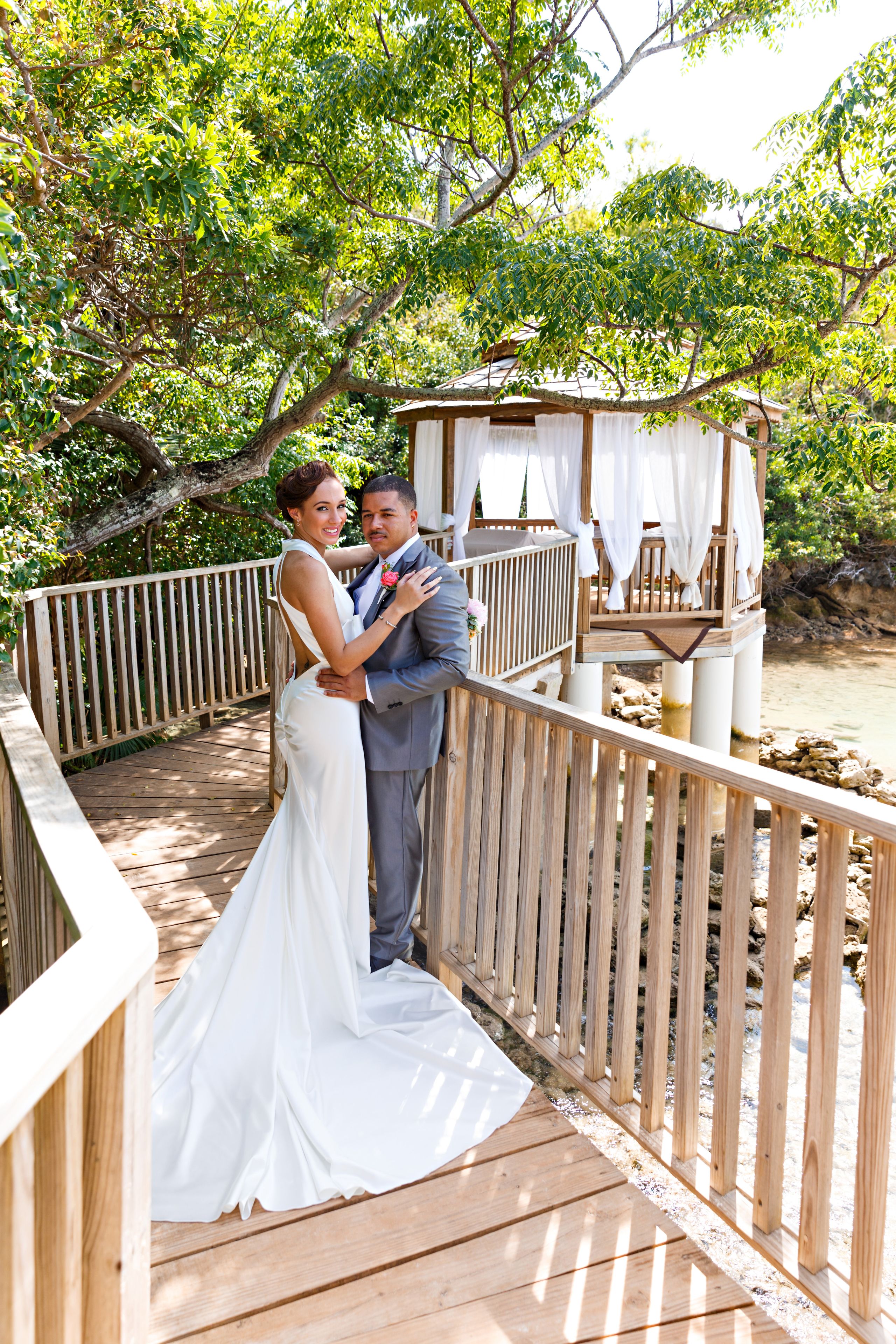 A wooden deck with a view of a river and trees.