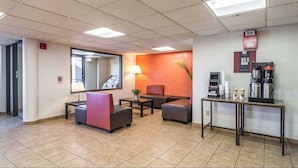 A lobby with seating areas, a reception desk, and a coffee station.