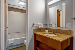A bathroom with a sink, mirror, and towel rack. - Motel 6 Elk Grove Village, IL - O'Hare (Elk Grove Village)