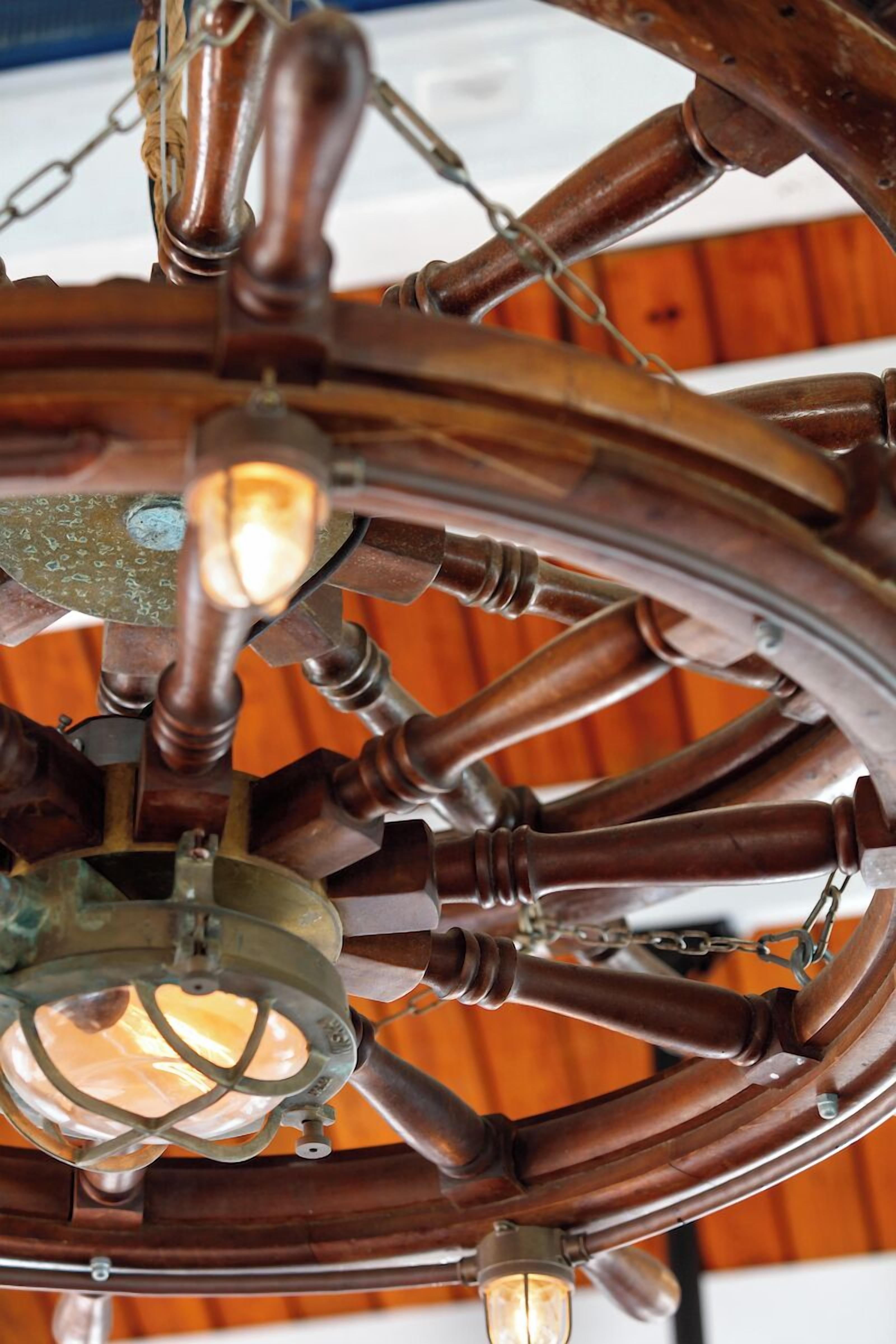 A close-up of a ceiling with a circular metal structure and hanging light fixtures.
