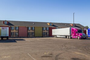 A parking lot with a large building in the background.
