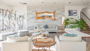 A modern living room with a sofa, coffee table, and decorative items.
