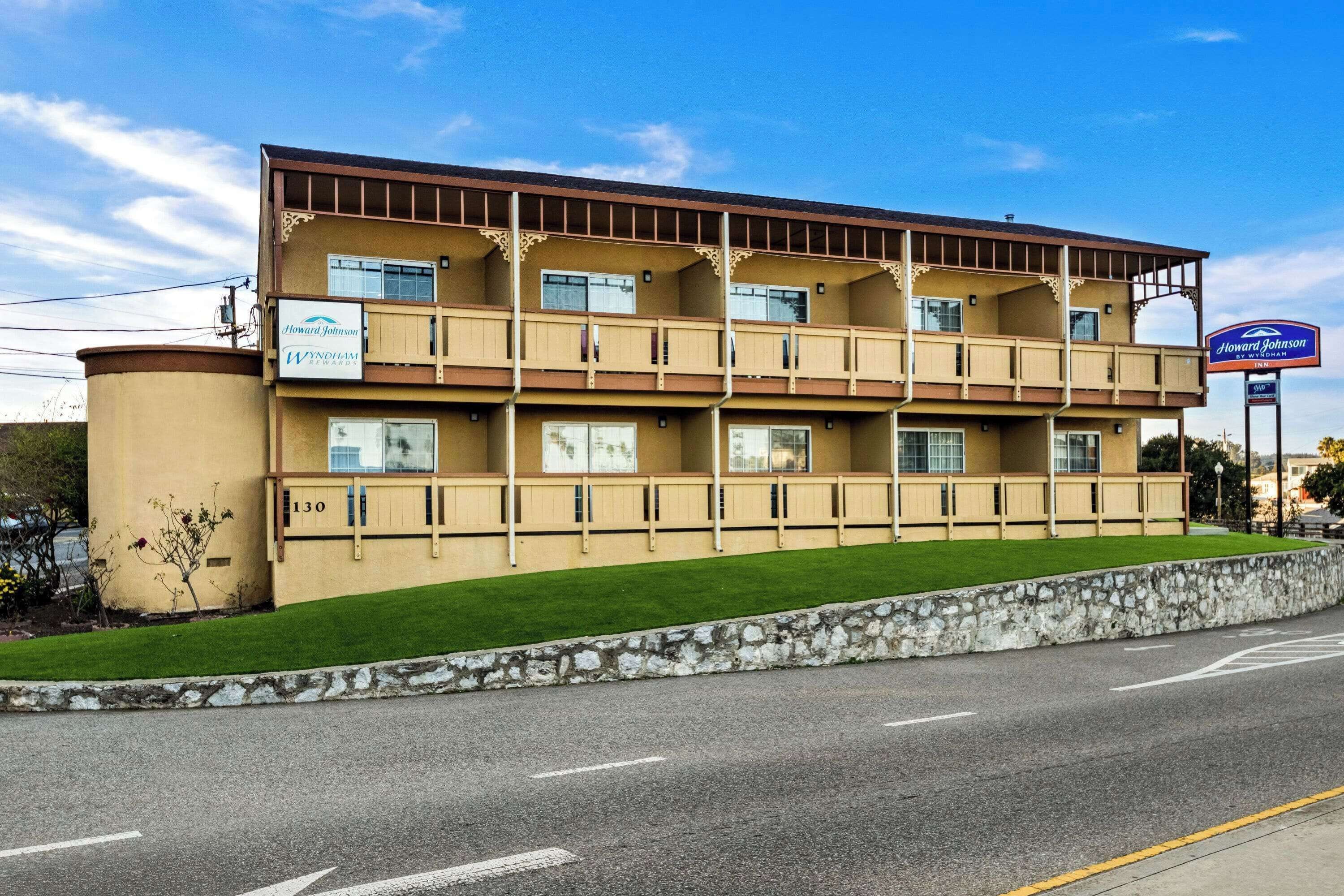 A multi-story hotel with a flat facade, multiple balconies, and a sign indicating Howard Johnson by Wyndham.