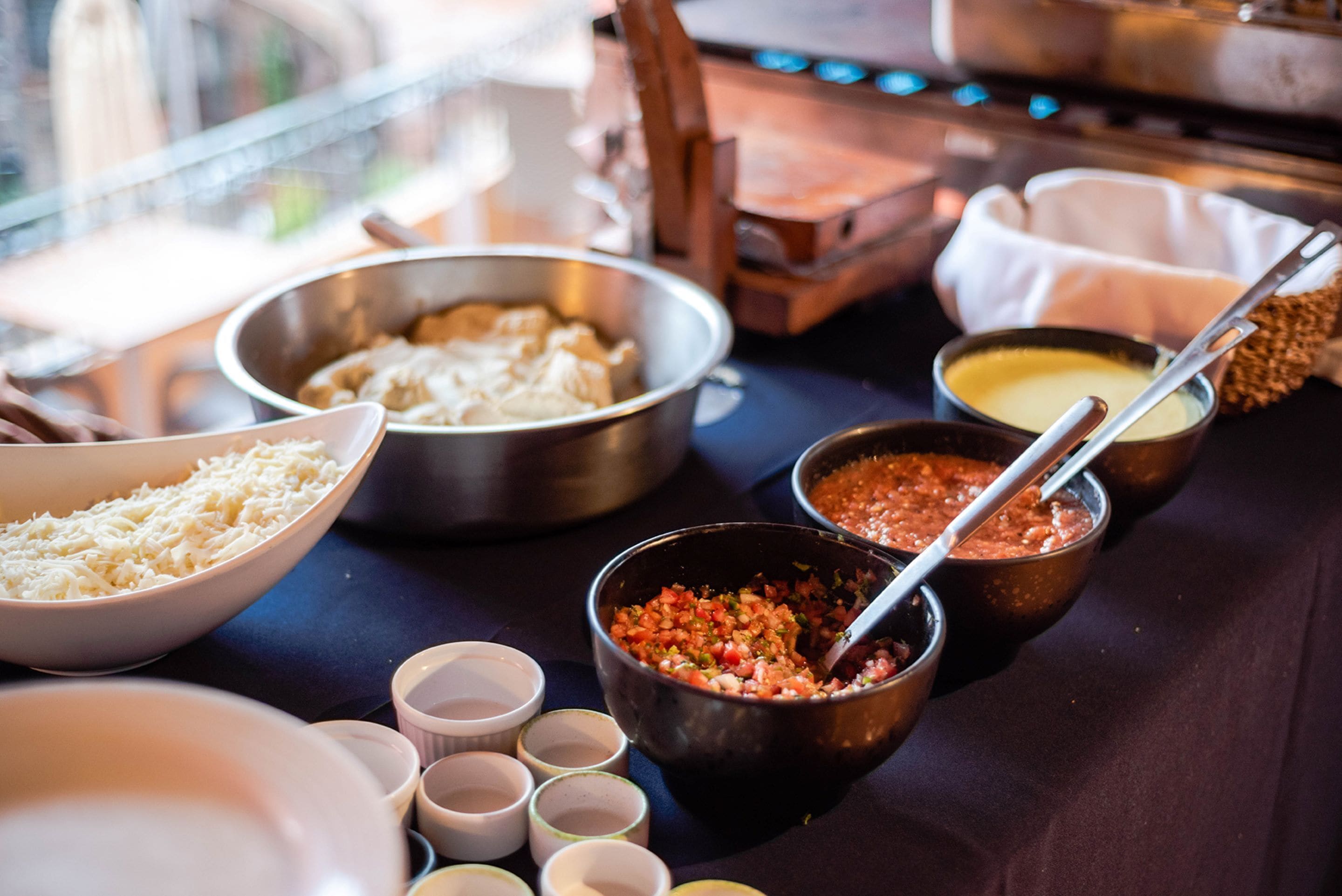 Una mesa de buffet con diversos platos y salsas.
