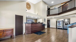 A spacious lobby with a reception desk, a vending machine, and a staircase leading to an upper level. - Sleep Inn Springfield West (Springfield)