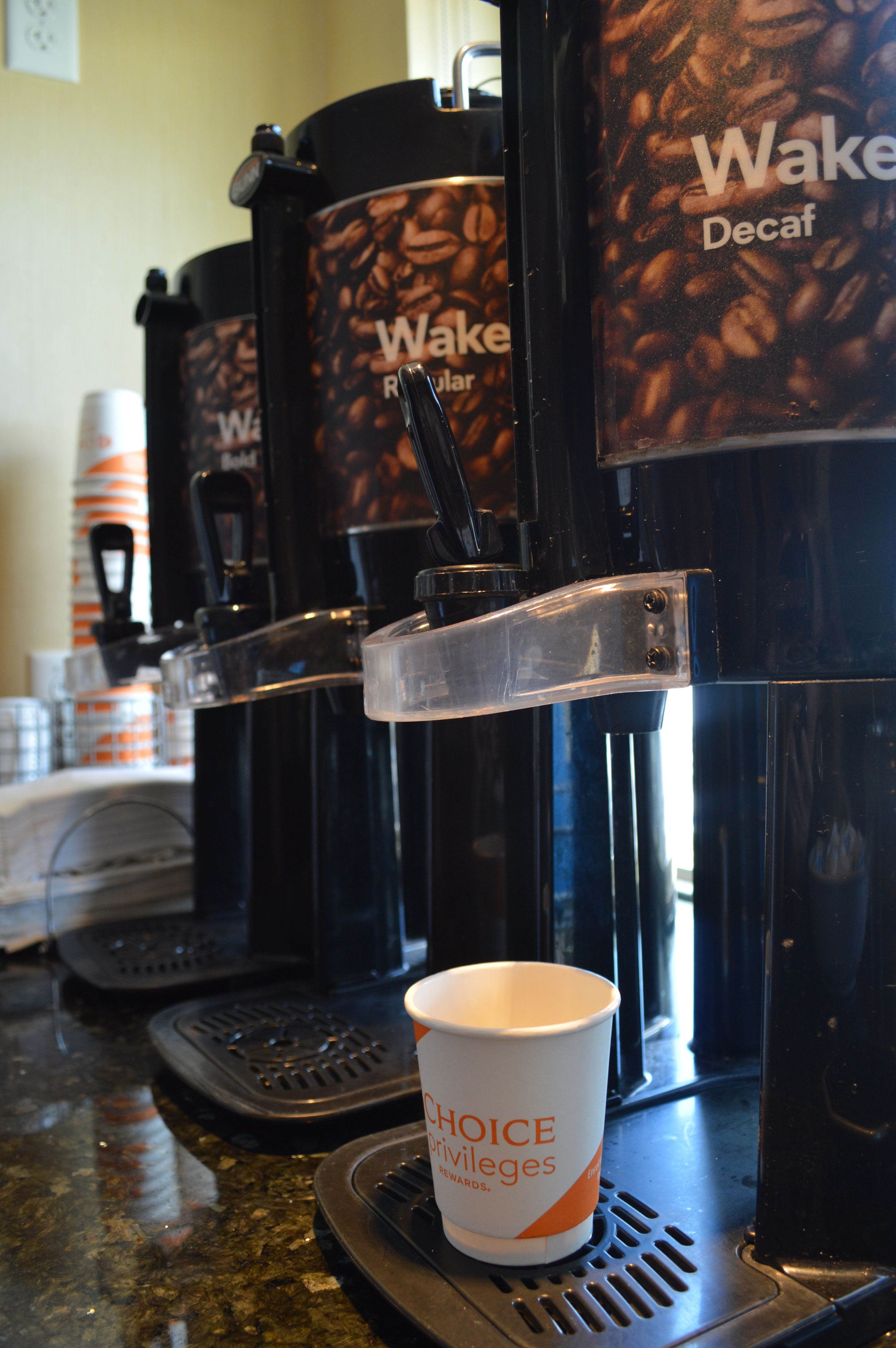 A coffee machine with a cup of coffee on the counter.