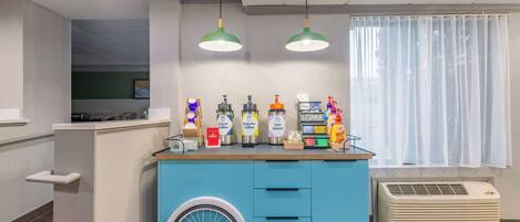 A counter with various beverage dispensers and a wheelchair-accessible design.
