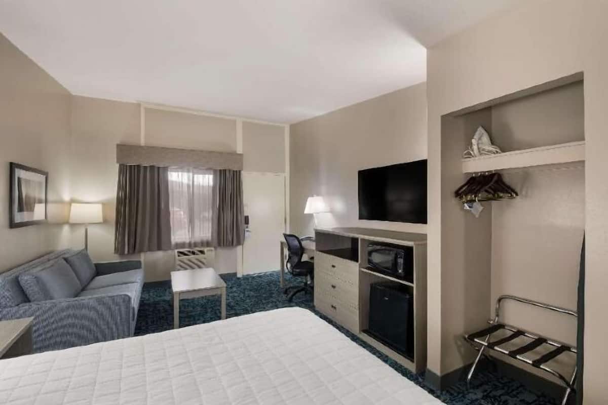 Desk, laptop workspace, blackout drapes, iron/ironing board