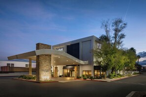 A modern hotel with a curved entrance, stone pillars, and a well-lit facade. - Fairfield Inn Las Vegas Convention Center (Las Vegas)