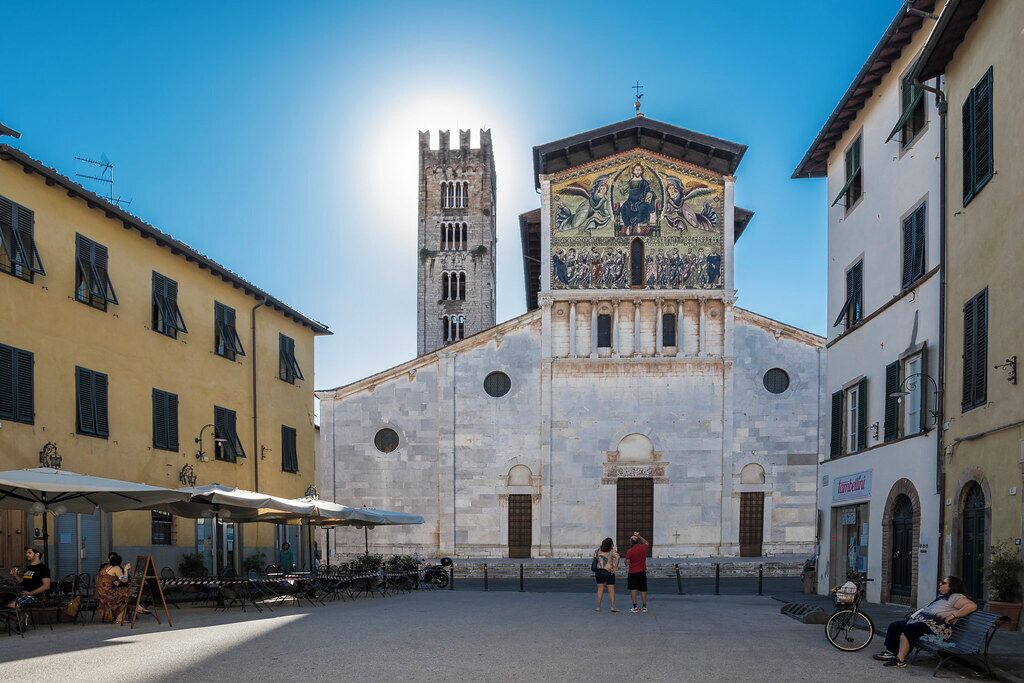 A historic building with a prominent tower and a detailed mosaic.