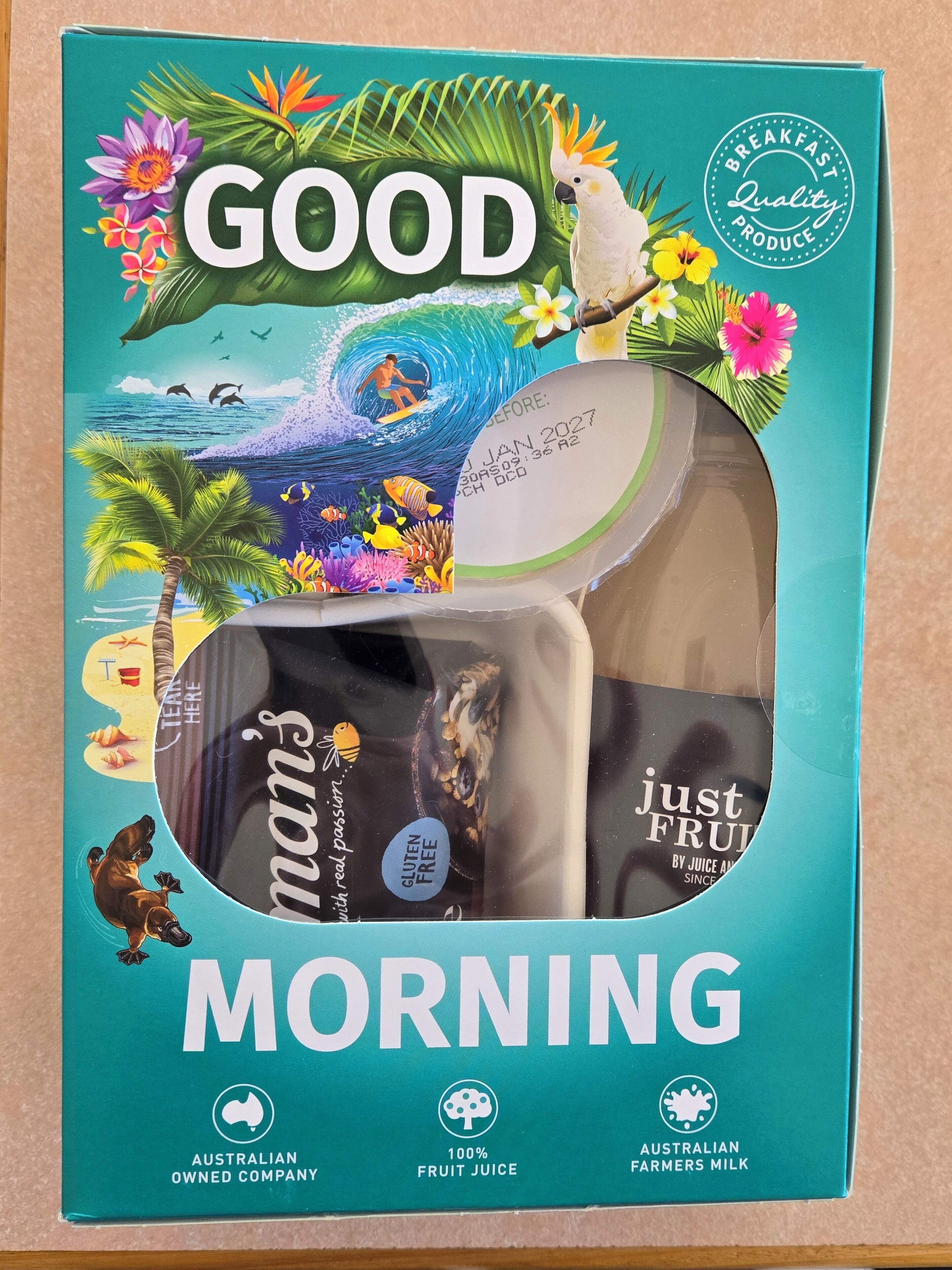 A breakfast box with tropical beach and ocean design, labeled 'GOOD MORNING'.