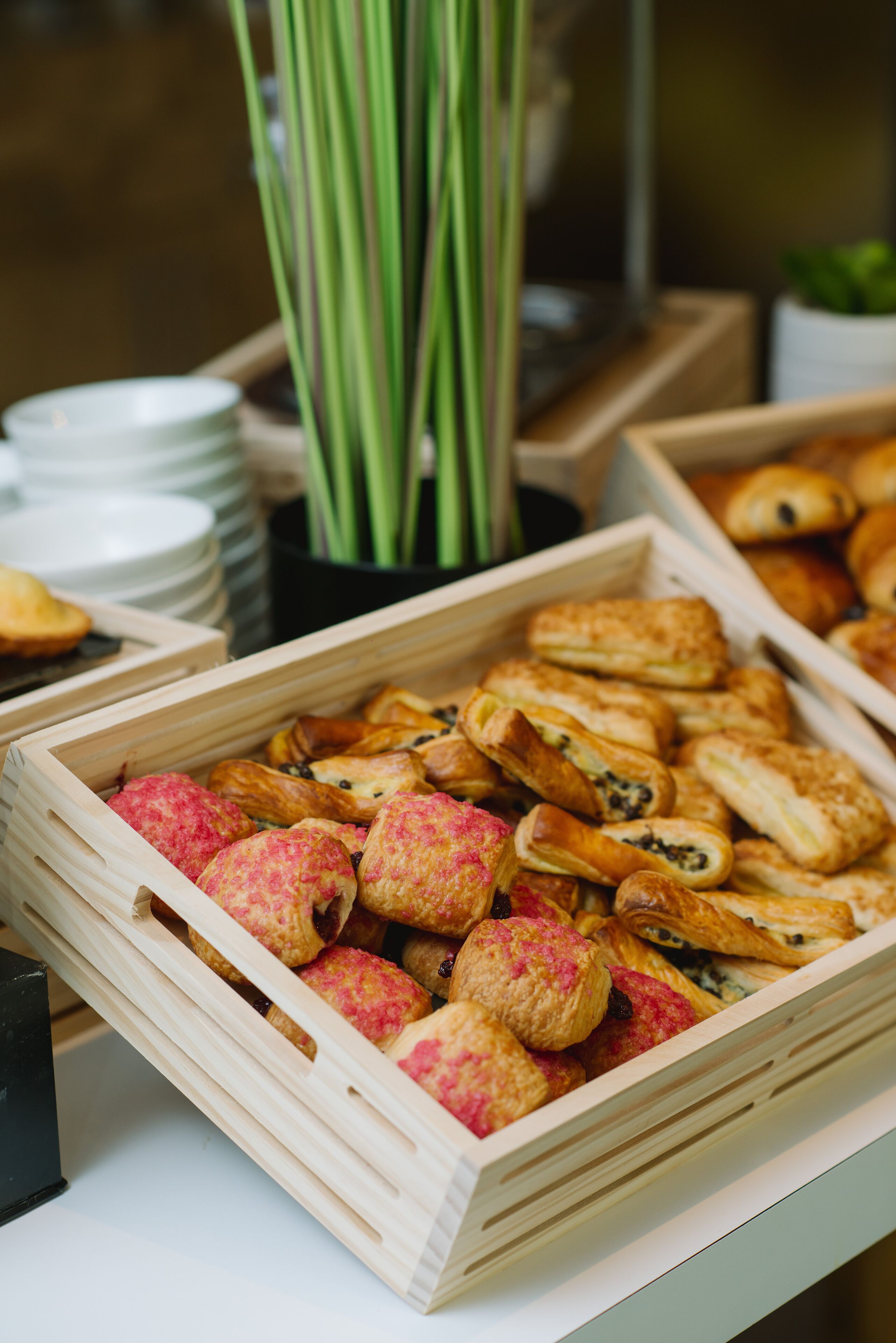 A wooden crate filled with assorted pastries.