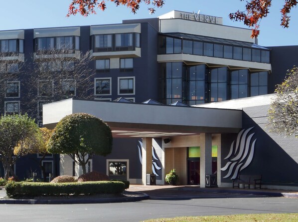 A modern building with a flat roof, large windows, and a sign reading "THE VERVE".