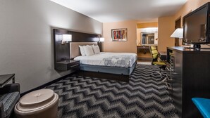 A hotel room with a bed, bedside tables, a desk, a chair, a television, and a window with blinds. - Best Western Jacksonville near Little Rock Air Force Base (Jacksonville)