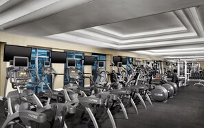 A gym with multiple exercise machines, including treadmills and elliptical trainers, arranged in rows. - Luxor Hotel and Casino (Las Vegas)
