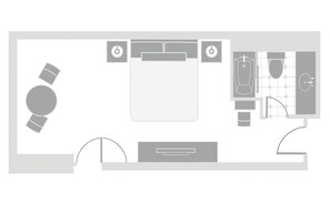 Un plan d’aménagement d’une chambre d’hôtel comprenant un lit, des tables de chevet, un bureau et une salle de bain.