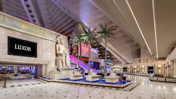 A spacious atrium with a central fountain, a Luxor store, and a sign for the Bodies exhibition.