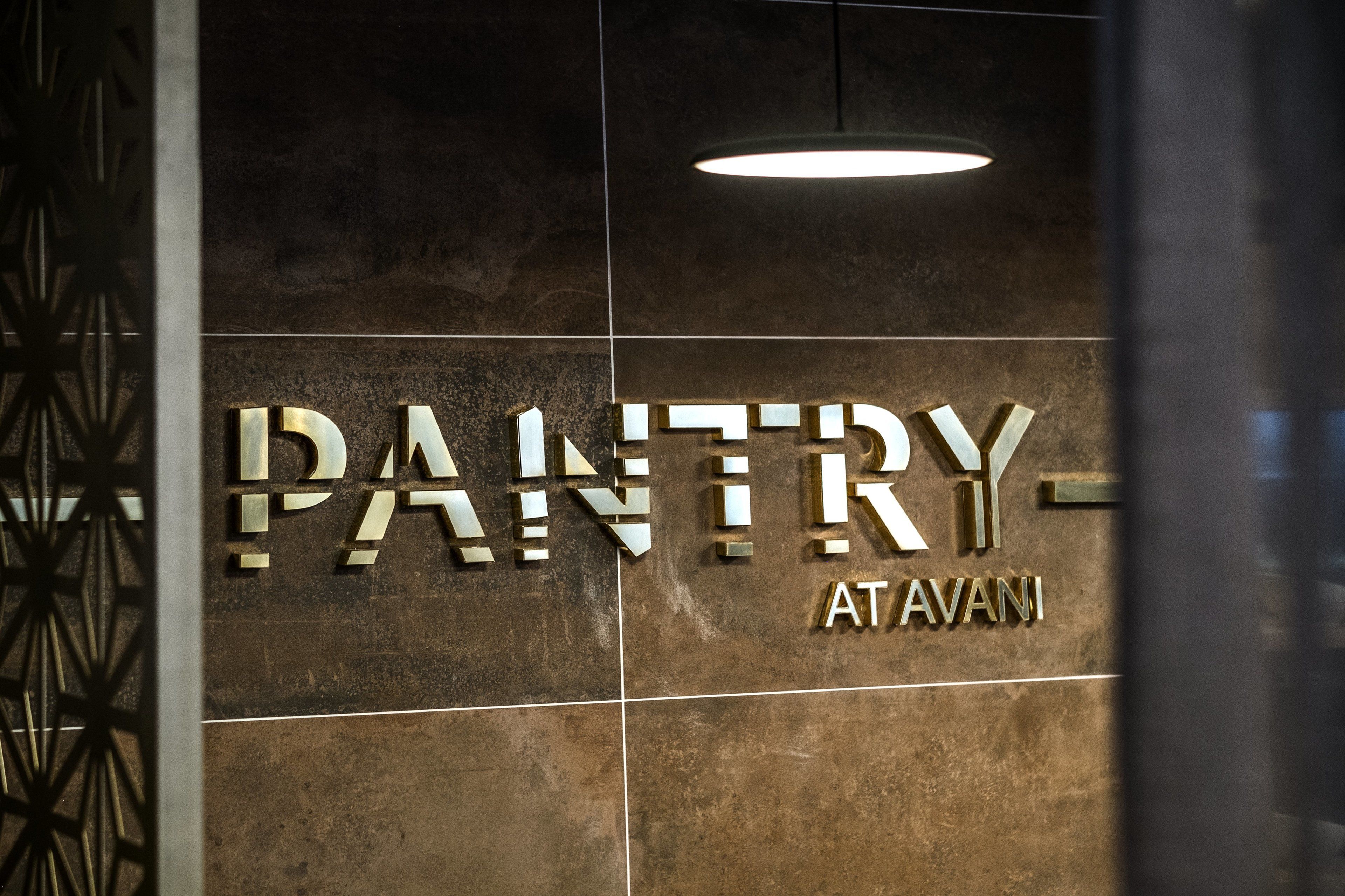 A sign with the word "PANTRY" and "ATAVANI" on a tiled wall.