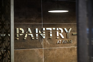 A sign with the word "PANTRY" and "ATAVANI" on a tiled wall. - Avani Windhoek Hotel & Casino (Windhoek)