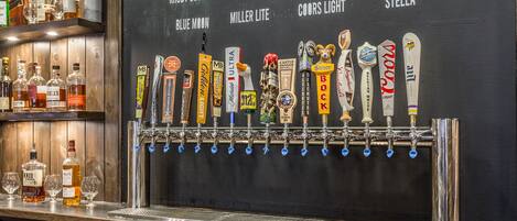 A bar with a tap system labeled with various beer brands.