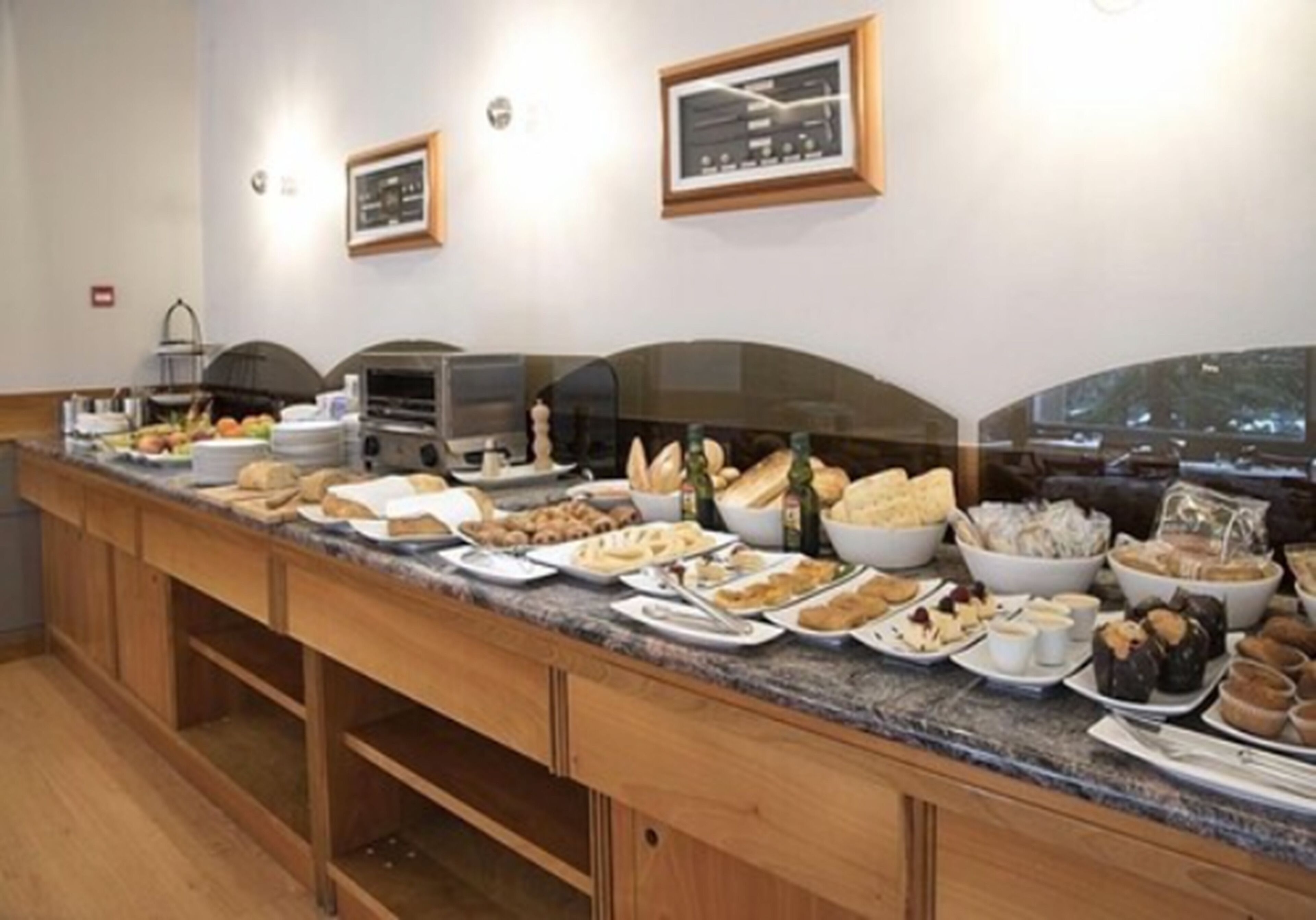A buffet setup with various food items and a coffee station.