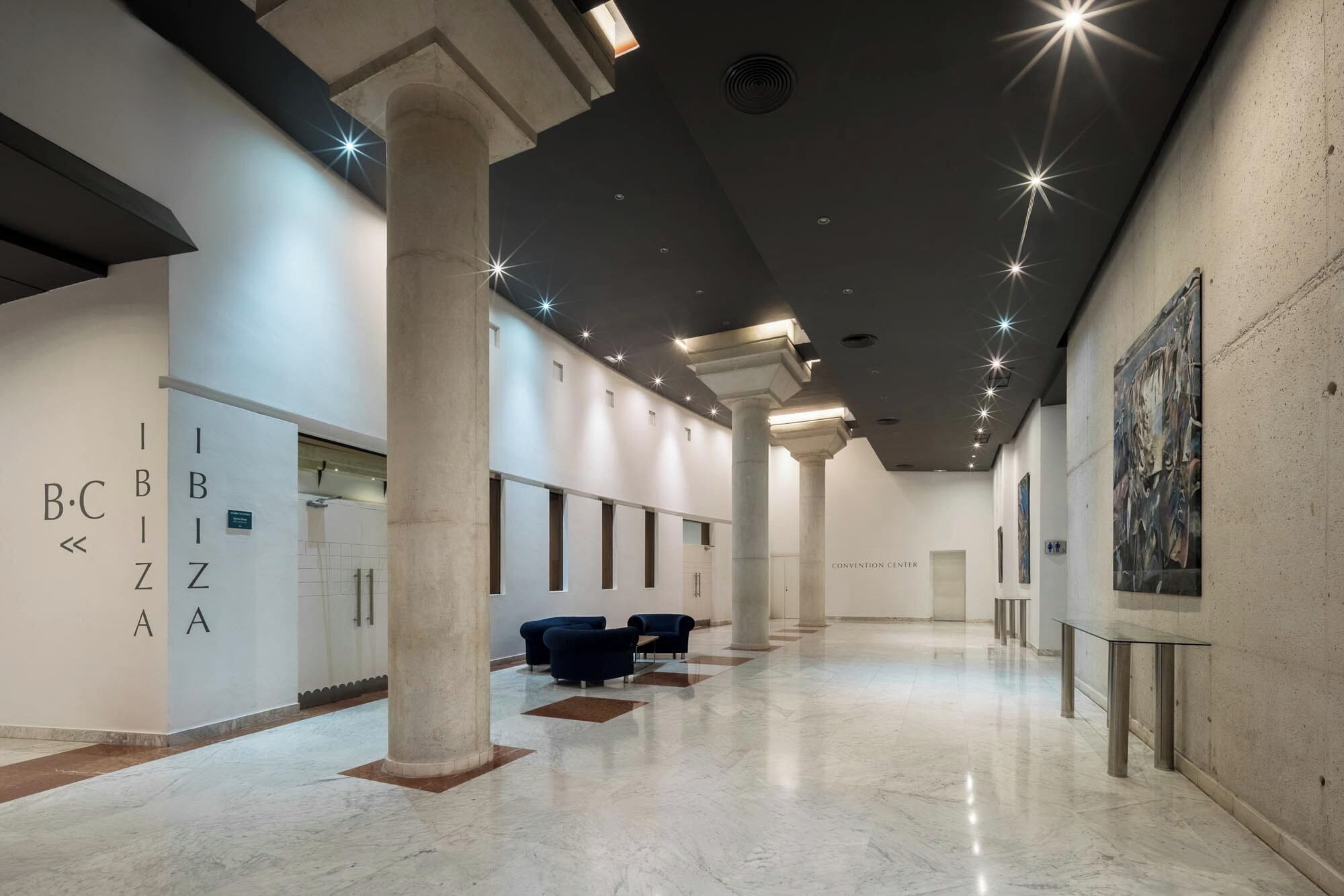 A spacious hallway with columns, a reception area, and a convention center.
