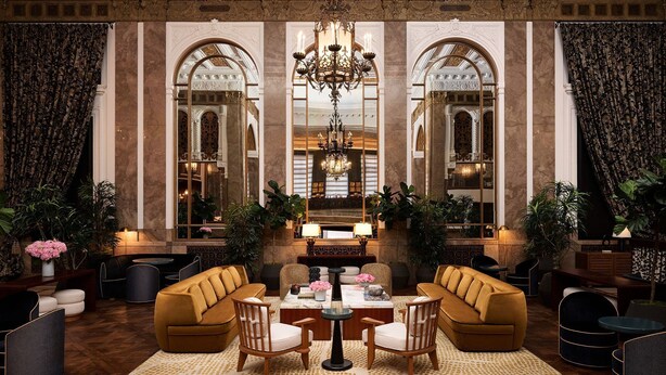 A lobby with a chandelier, seating area, and large mirrors. - Beacon Grand, A Union Square Hotel  (San Francisco)