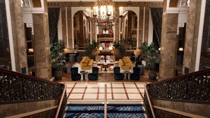 A grand lobby with a chandelier, sofas, and a staircase. - Beacon Grand, A Union Square Hotel  (San Francisco)