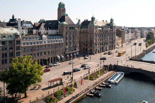 A waterfront hotel with a prominent building, a pedestrian bridge, and a canal. - Elite Hotel Savoy (Malmö)