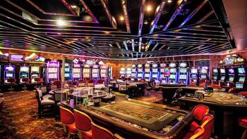 Experience the excitement of gaming at our casino, where tables and slot machines await your next bet.