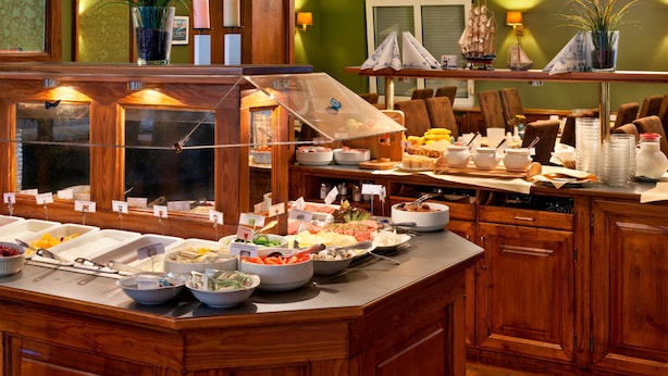 A buffet setup with various food items and a glass display case.