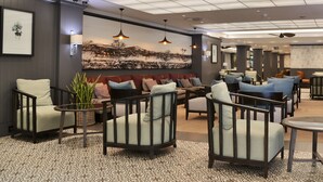 A modern lounge area with seating arrangements, pendant lighting, and a large wall-mounted artwork. - Avani Gaborone Resort & Casino (Gaborone)