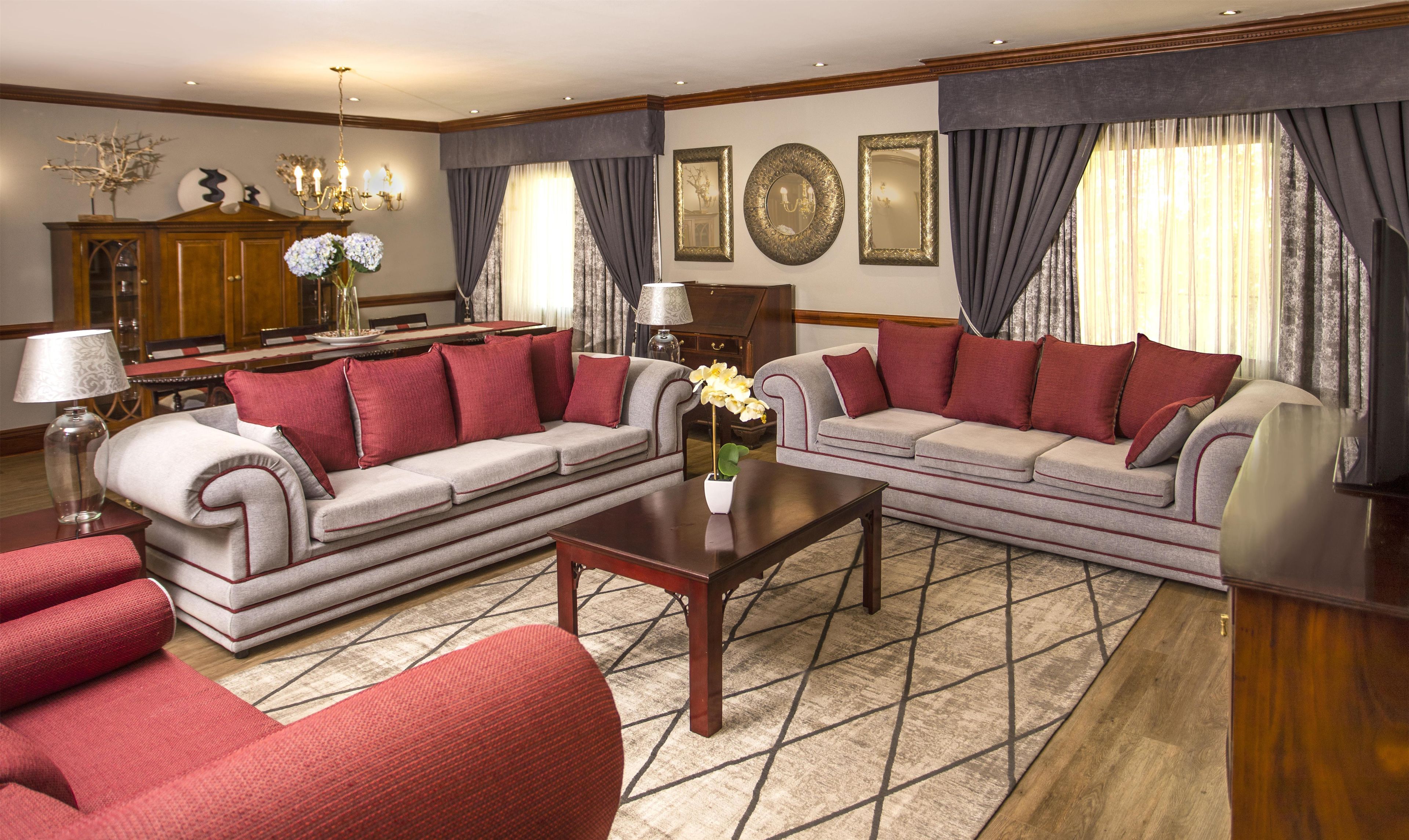 A living room with a sofa set, a coffee table, and a lamp.