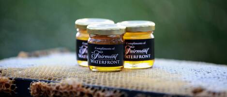 Three jars of honey labeled "Compliments of the Fairmont Waterfront."