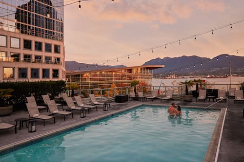 Outdoor pool, a heated pool, pool umbrellas, pool loungers
