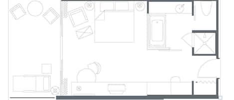 Un plan d’étage d’hôtel comprenant un couloir central, plusieurs chambres, une salle de bain et un coin repas.
