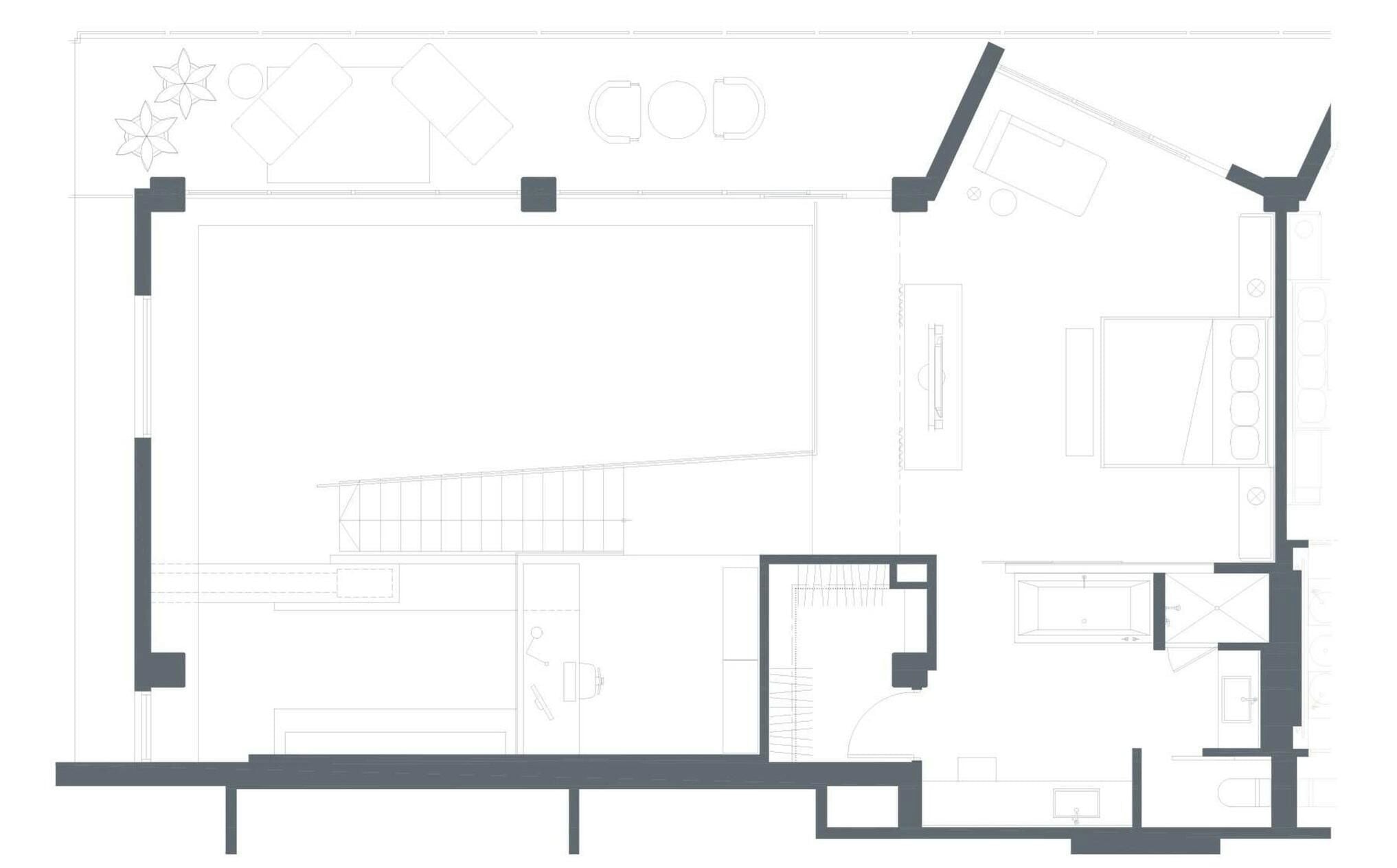 A floor plan with a large central open space, a kitchen area, and a dining area.