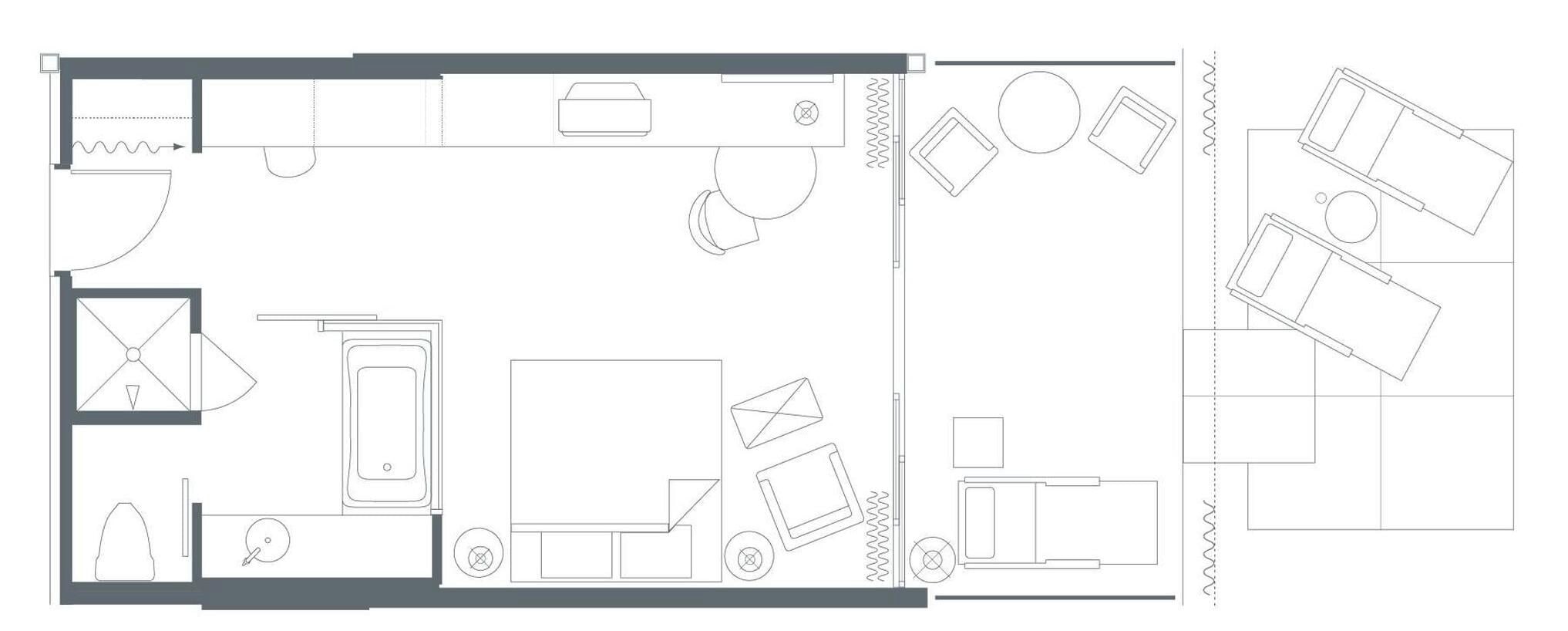 A floor plan of a hotel room with a bed, a desk, a chair, a bathroom, and a small sitting area.