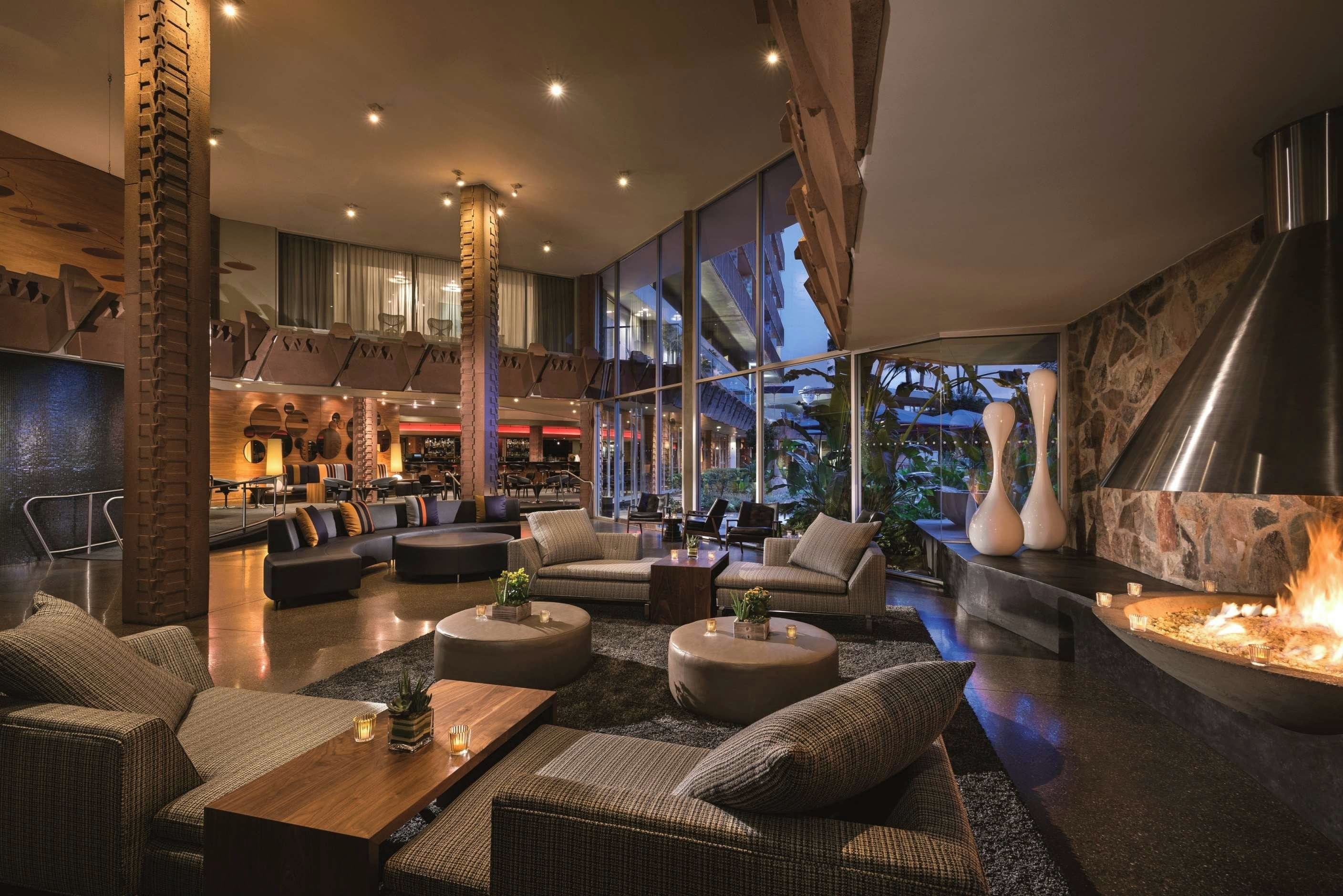 A modern lounge area with seating, a bar, and a fireplace.