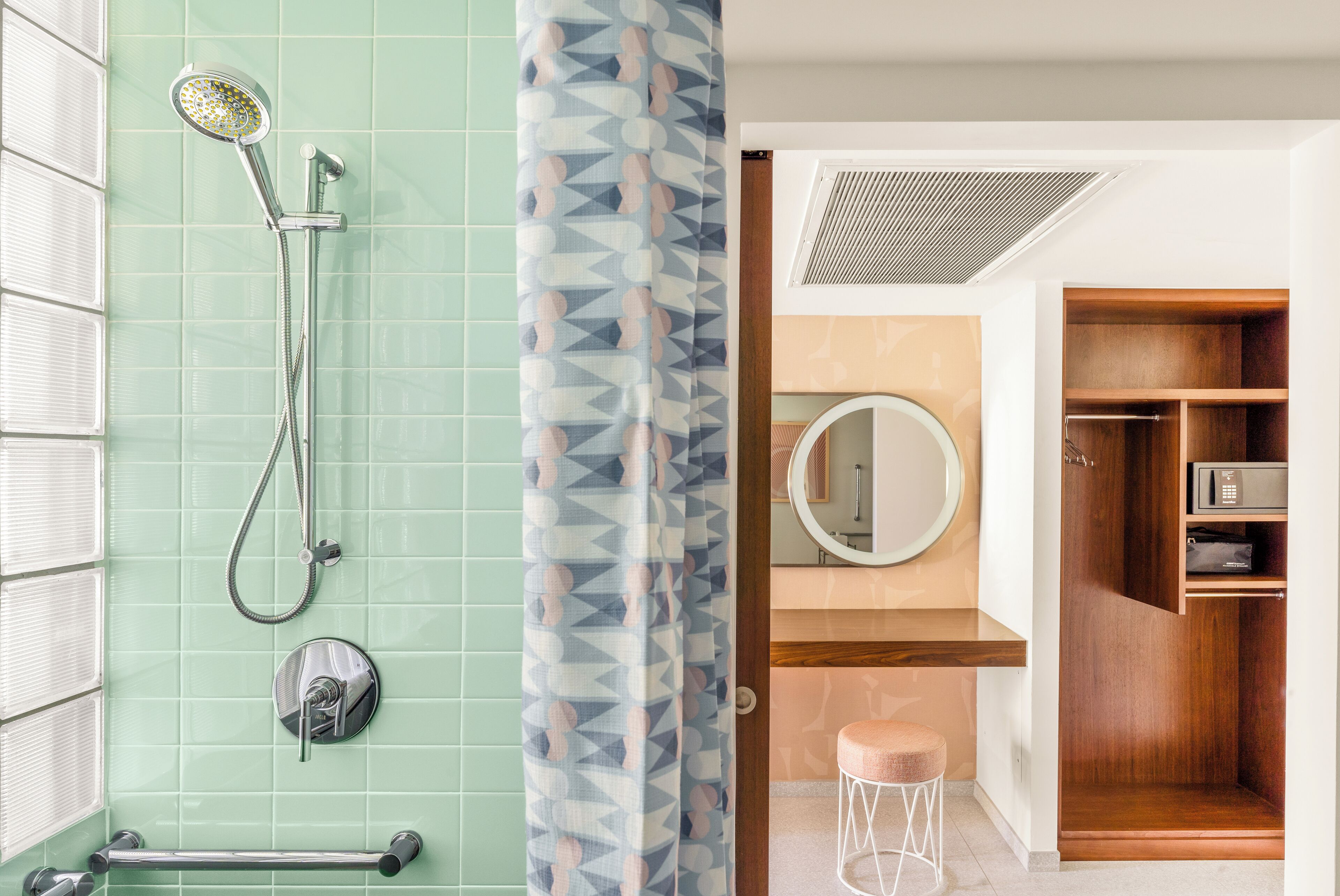 A bathroom with a shower, a toilet, a sink, and a mirror.