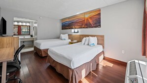 A hotel room with two beds, a desk with a chair, a TV, and a large painting on the wall. - Days Inn by Wyndham Nashville Saint Thomas West Hospital (Nashville)