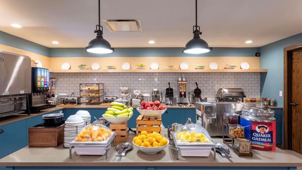 A well-equipped kitchen with various food items, utensils, and appliances. - Country Inn & Suites by Radisson, Fargo, ND (Fargo)