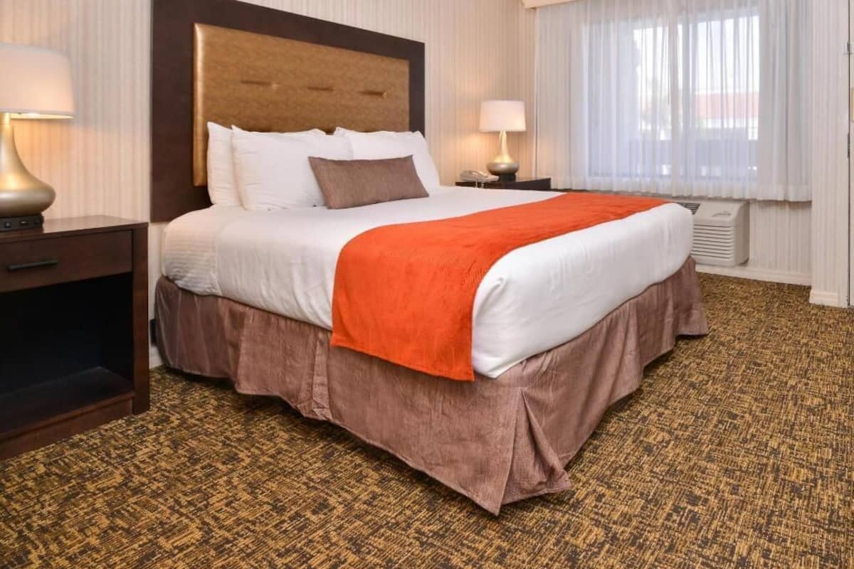 Premium bedding, desk, laptop workspace, blackout drapes