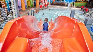 Enjoy water-based fun for all ages at this vibrant indoor water park with a thrilling slide, pool, and play structures.