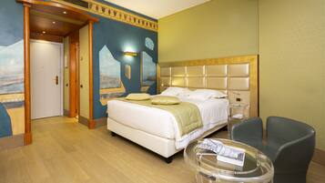 Junior Suite | Minibar, in-room safe, individually decorated, desk