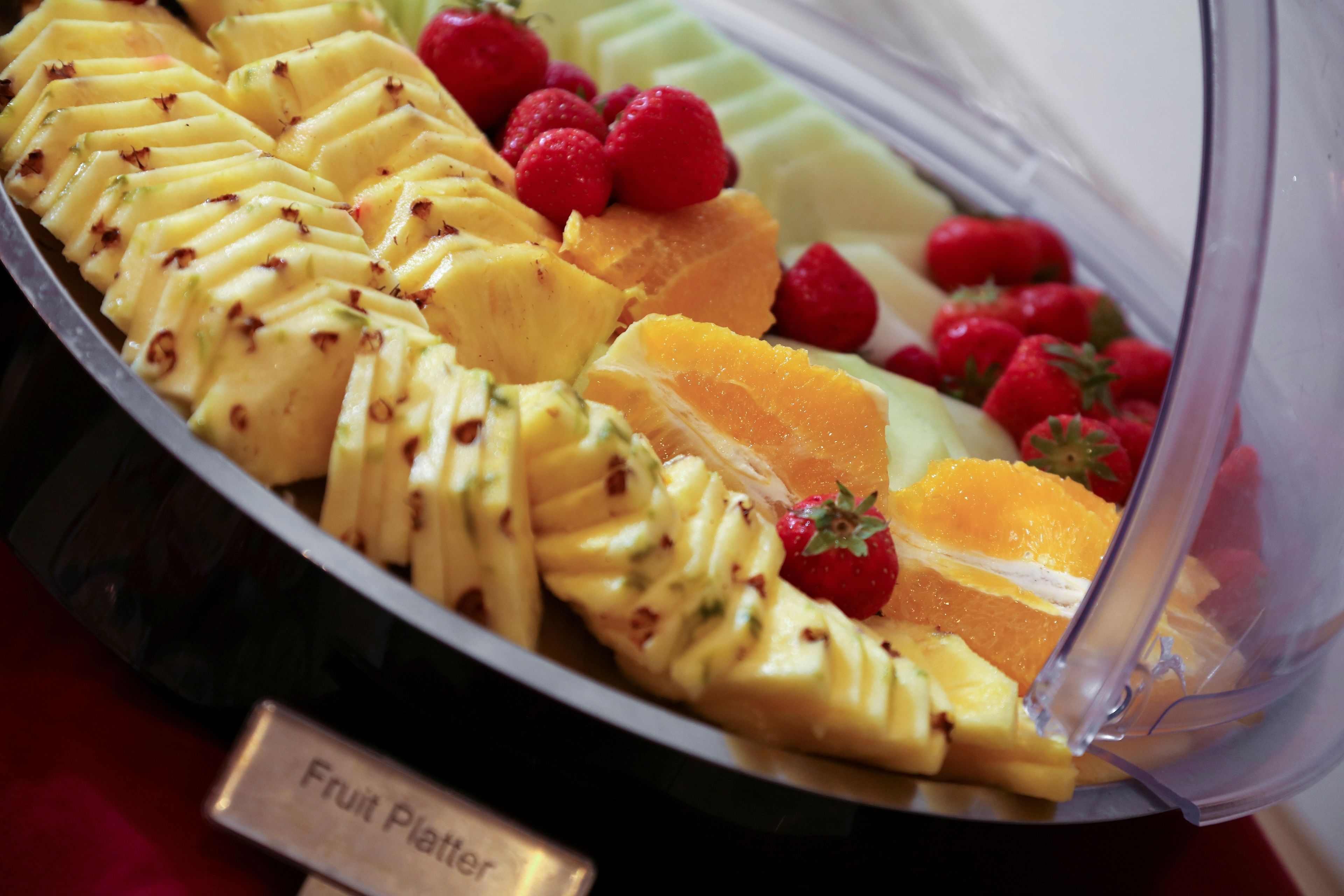 A fruit platter with sliced fruits and berries.