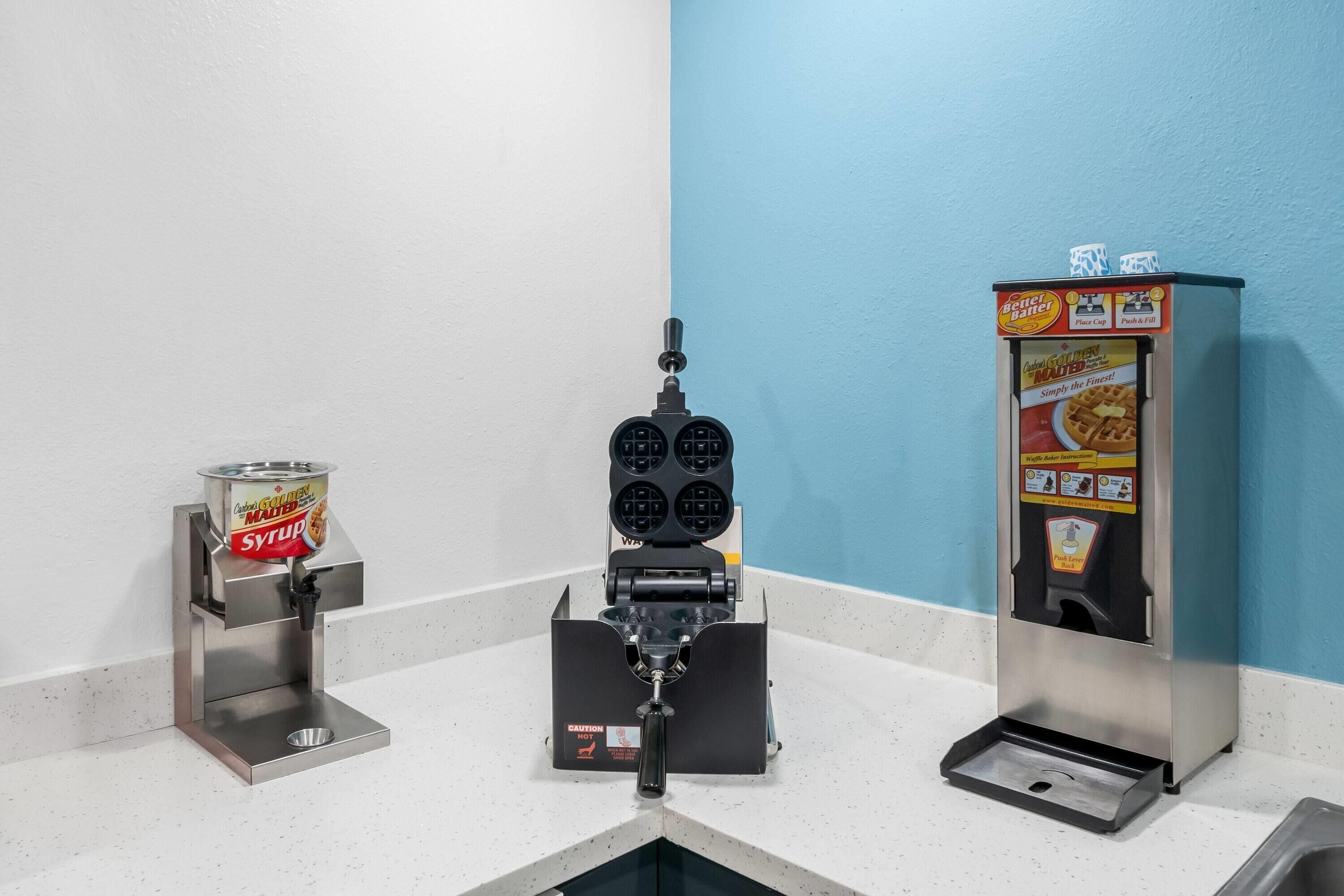 A waffle maker with syrup dispensers and a waffle maker with instructions.