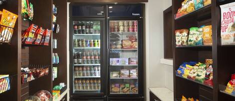 A snack and beverage vending area with two refrigerators, one labeled 'cold' and the other 'frozen'.