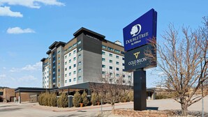A hotel with a modern design, featuring a prominent sign for the Doubletree by Hilton Gold Bristol Grill.