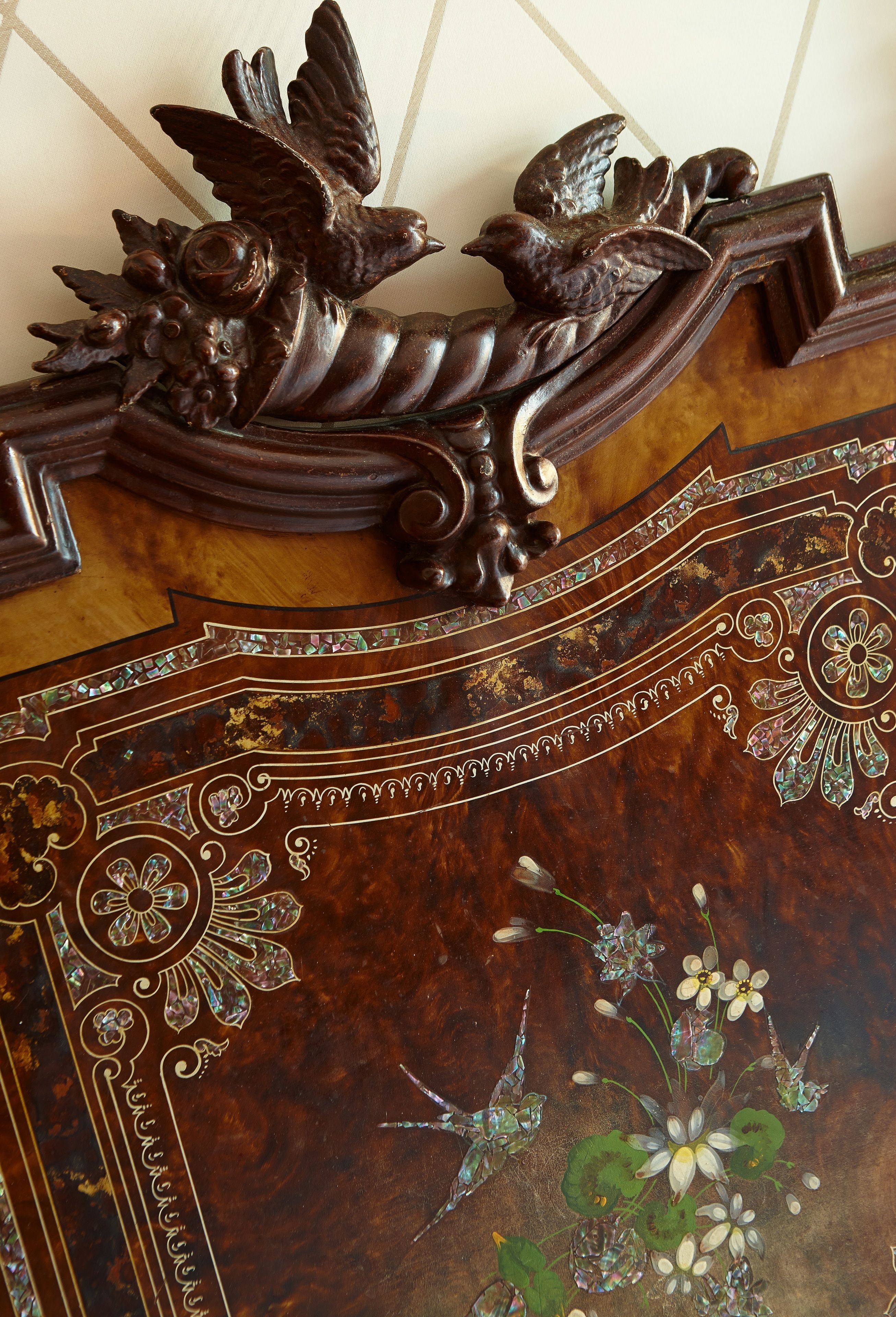 A detailed wooden panel with intricate carvings and floral designs.